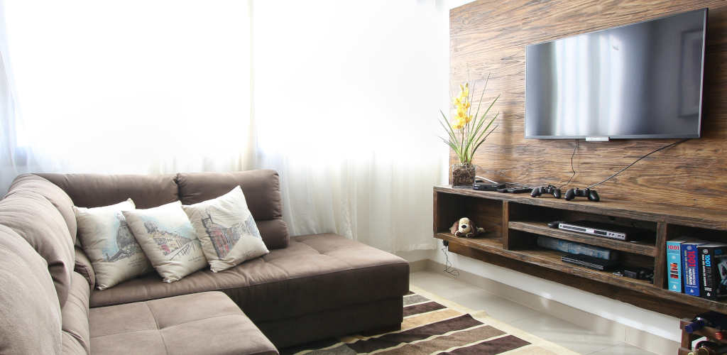 living room with couch facing a large TV