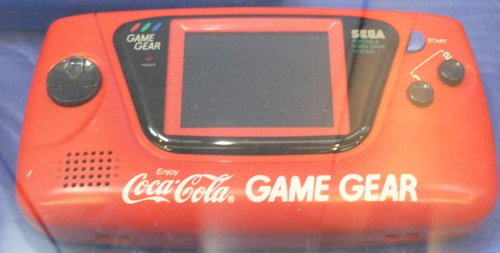 A red sega Game gear with Coca Cola Branding