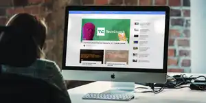 A woman looking at the Linux Impact homepage on a mac