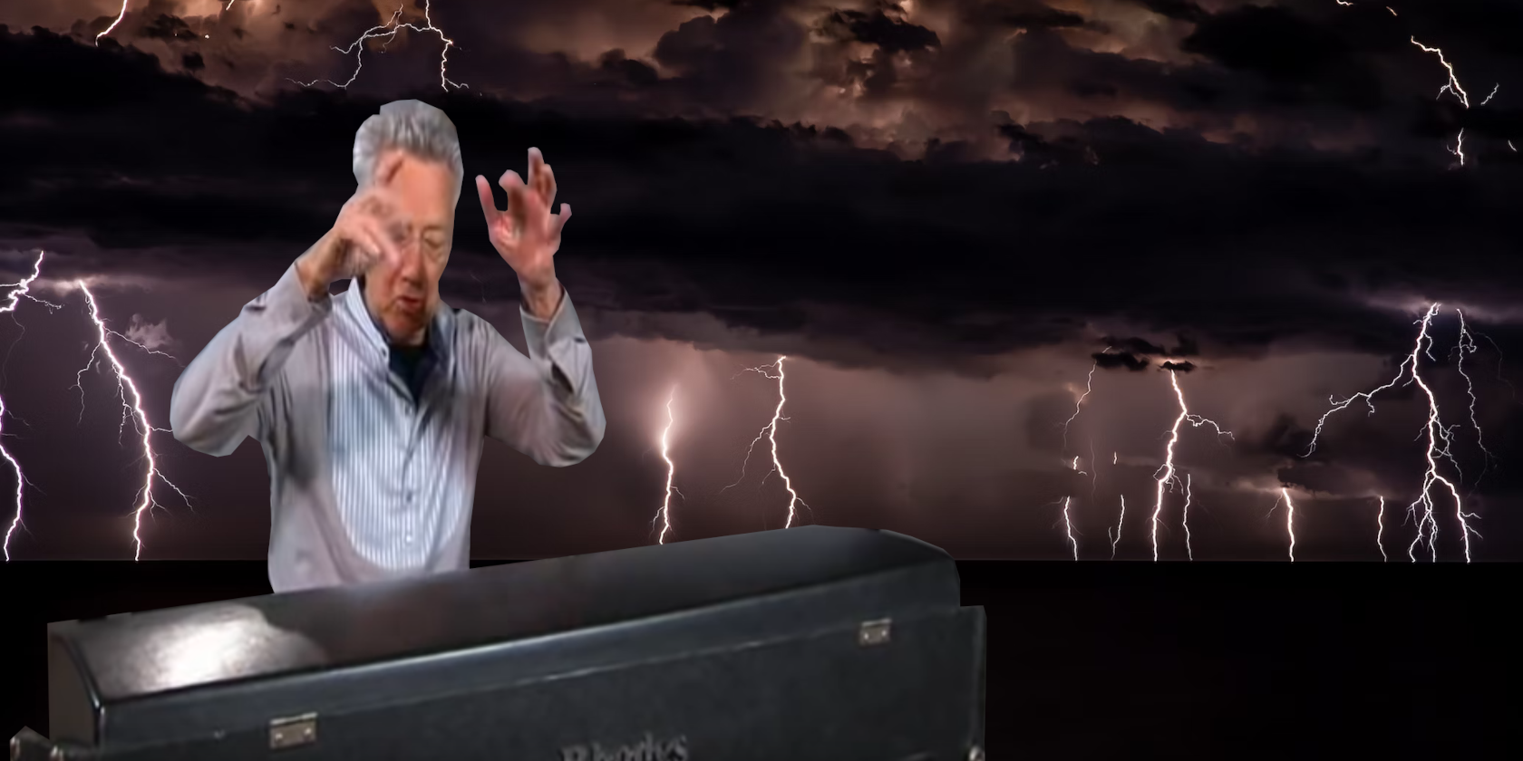 Ray Manzarek playing the organ against the background of a storm