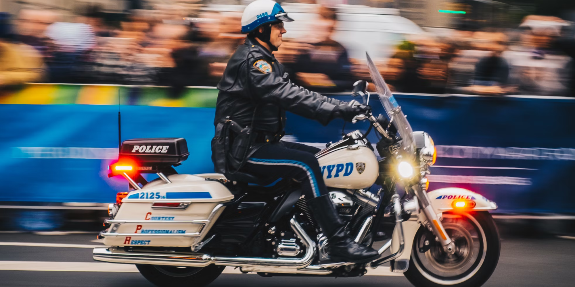 NYPD police motorcycle speeding against a blurred background