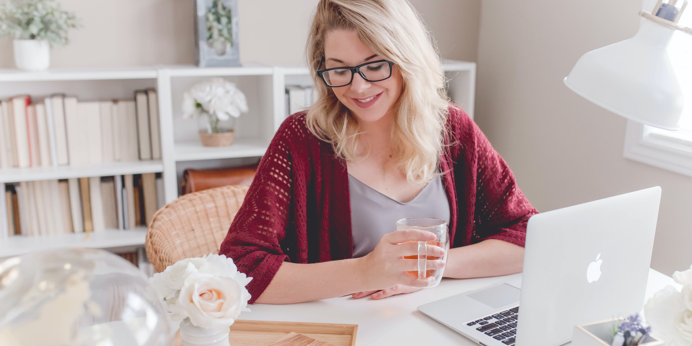 Blonde woman enjoying a cup of tea while installing docker-autocompose