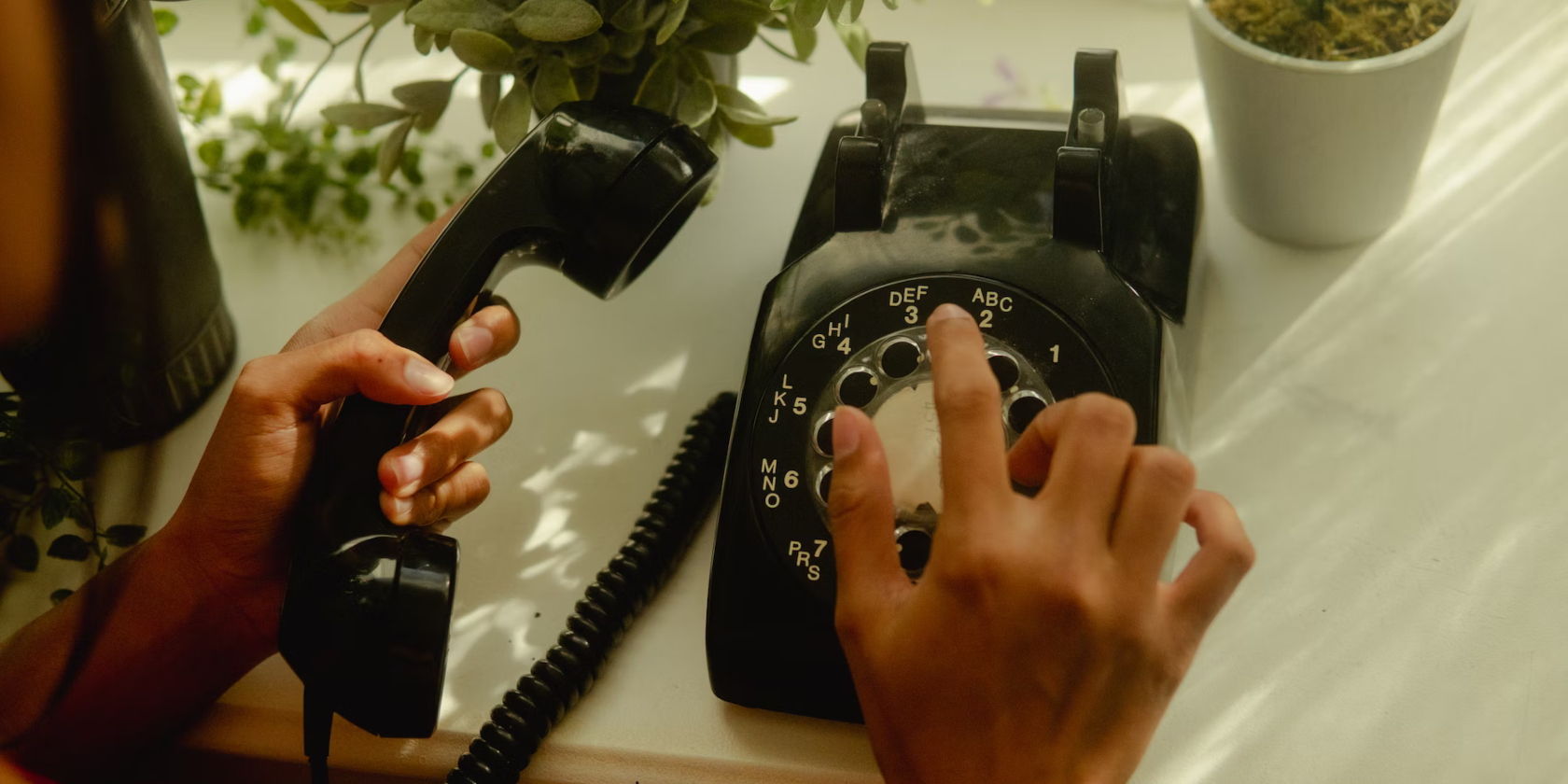 A hand dialling on an old-style rotary telephone