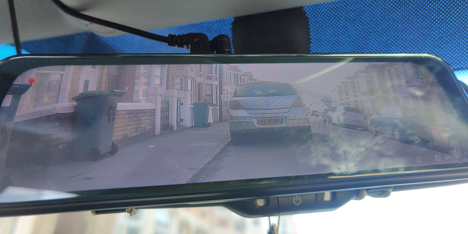 Rearview mirror showing parked cars