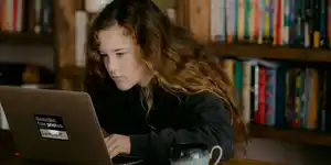 A girl in a library using a laptop