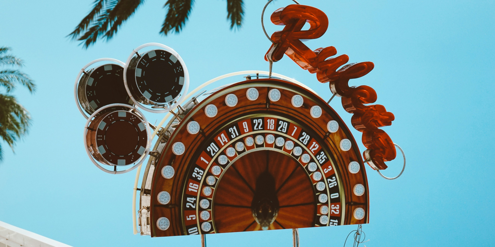 A sign advertising roulette against a blue sky